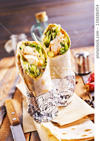 Tortilla wraps with chicken fillet and vegetables. Tortilla wraps with chicken fillet and vegetables. 138886954