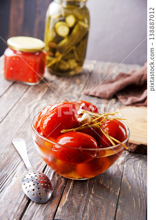 Assortie Jars of Marinated vegetables picles tomato on a wooden background Assortie Jars of Marinated vegetables picles tomato on a wooden background 138887012