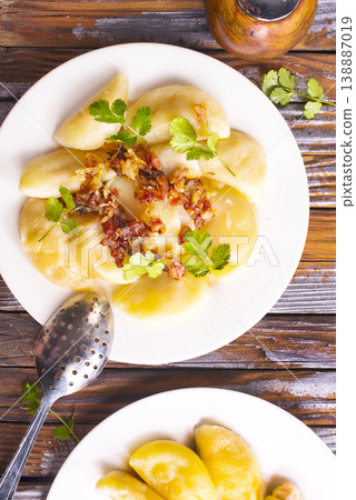 Dumplings with fried onions on white plate. Varenyky, vareniki, pierogi. Dumplings with fried onions on white plate. Varenyky, vareniki, pierogi. 138887019