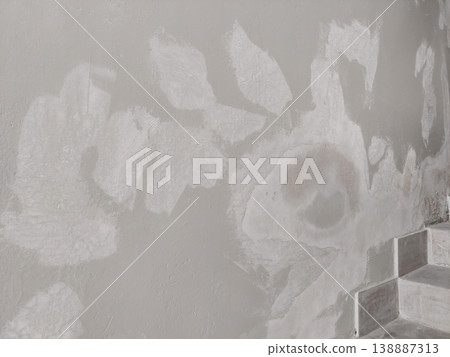 Wall plaster repair patches with rough texture and unfinished surface after renovation work Wall plaster repair patches with rough texture and unfinished surface after renovation work 138887313