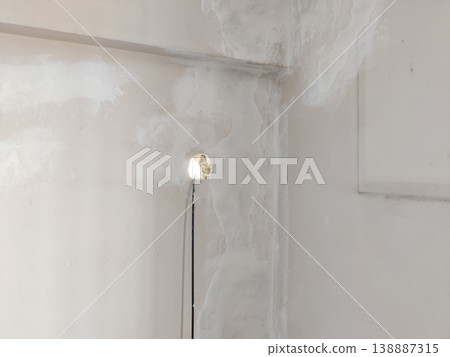 Water damaged wall with visible hole and cable showing damp plaster and decay Water damaged wall with visible hole and cable showing damp plaster and decay 138887315