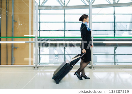Female flight attendant walking through the airport (Photo courtesy of Kansai International Airport (KIX)) Female flight attendant walking through the airport (Photo courtesy of Kansai International Airport (KIX)) 138887319