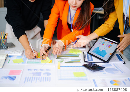 Business People Talking Discussing with financial document data charts and graphs Team business meeting with smart phone and laptop and digital tablet computer Business People Talking Discussing with financial document data charts and graphs Team business meeting with smart phone and laptop and digital tablet computer 138887408