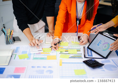 Business People Talking Discussing with financial document data charts and graphs Team business meeting with smart phone and laptop and digital tablet computer Business People Talking Discussing with financial document data charts and graphs Team business meeting with smart phone and laptop and digital tablet computer 138887413