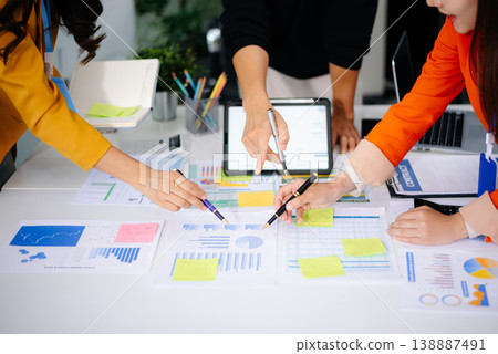 Business team collaboration discussing working analyzing with financial data and marketing growth report graph in team, presentation and digital tablet, laptop Business team collaboration discussing working analyzing with financial data and marketing growth report graph in team, presentation and digital tablet, laptop 138887491
