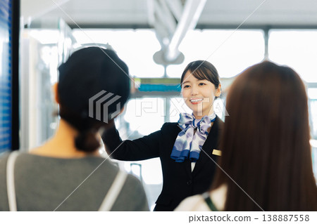 Female airport ground staff guiding travelers (Photo courtesy of Kansai International Airport (KIX)) Female airport ground staff guiding travelers (Photo courtesy of Kansai International Airport (KIX)) 138887558
