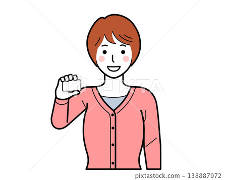 面向前方。一位身穿開襟羊毛衫的年輕女子手持一張卡片。 面向前方。一位身穿開襟羊毛衫的年輕女子手持一張卡片。 138887972