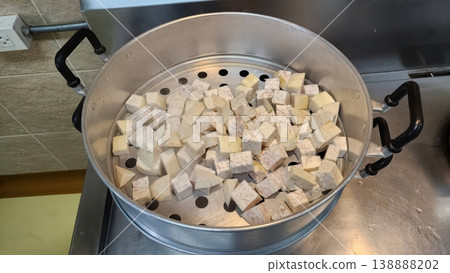 Diced Fresh Taro Root Chunks in a Large Aluminum Steamer Pot 138888202