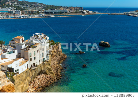 White houses on the cliff overlooking Mediterranean sea in Ibiza, Spain. White houses on the cliff overlooking Mediterranean sea in Ibiza, Spain. 138889903