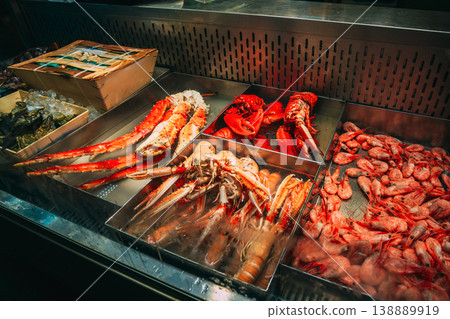 Trade in seafood seafood in the local Market. Close-up of a gourmet seafood display with lobsters, crabs, and fresh fish on ice at indoor market hall. Close-up of a gourmet seafood display with Trade in seafood seafood in the local Market. Close-up of a gourmet seafood display with lobsters, crabs, and fresh fish on ice at indoor market hall. Close-up of a gourmet seafood display with 138889919