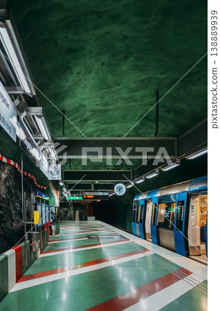 Kungstradgarden metro station with blue train and painted rock walls, Stockholm Kungstradgarden metro station with blue train and painted rock walls, Stockholm 138889939