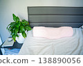 Ergonomic orthopedic pillow on bed in modern bedroom interior. Cervical support pillow for proper neck alignment, posture correction and comfortable healthy sleep at home 138890056