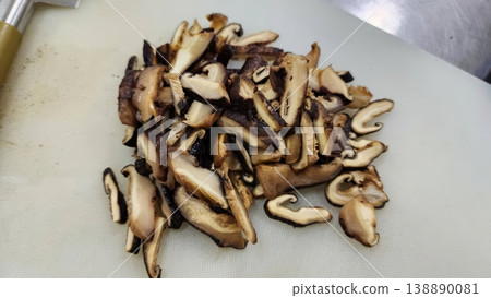 Freshly Sliced Shiitake Mushrooms on White Cutting Board Prepared for Cooking Freshly Sliced Shiitake Mushrooms on White Cutting Board Prepared for Cooking 138890081
