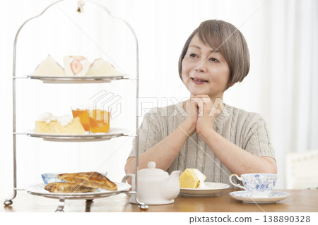 Senior women enjoying afternoon tea Senior women enjoying afternoon tea 138890328
