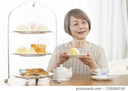 Senior women enjoying afternoon tea Senior women enjoying afternoon tea 138890330