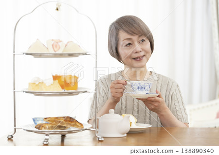 Senior women enjoying afternoon tea Senior women enjoying afternoon tea 138890340