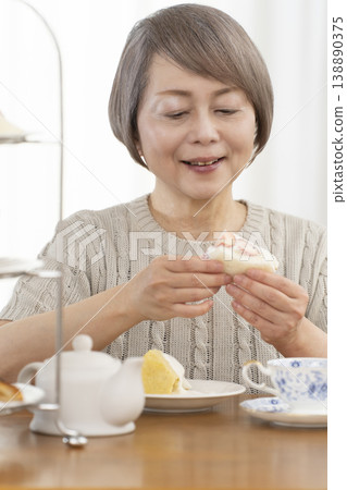 Senior women enjoying afternoon tea Senior women enjoying afternoon tea 138890375