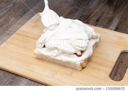 The process of making a strawberry fruit sandwich 138890635