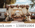 A wedding tent is set up in a garden. It features floral decorations and a seating area. Guests can gather here for the celebration during the afternoon light 138891064