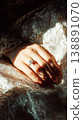 Close-up view of a brides hands resting on soft fabric. The hands feature a modern manicure that adds to the bridal look during wedding preparations 138891070