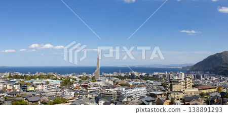 A view of Beppu city from the top of a hill, with Oita city visible in the distance. A view of Beppu city from the top of a hill, with Oita city visible in the distance. 138891293