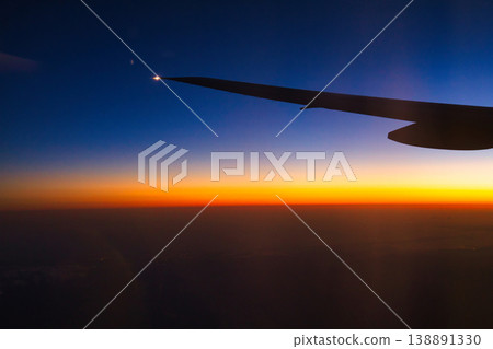 A sunset glow seen from an airplane A sunset glow seen from an airplane 138891330