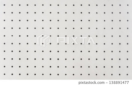 Perforated walls of a soundproof room with regularly spaced holes. 138891477
