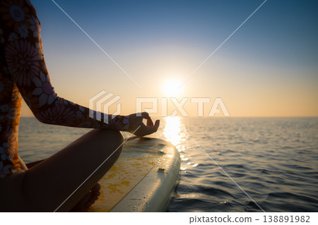 Young woman walking on sup board by the sea during summer vacation Young woman walking on sup board by the sea during summer vacation 138891982