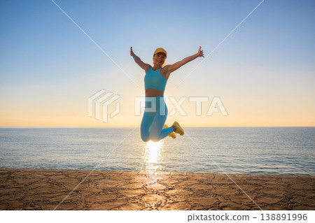 Fit woman jumping at the beach during summer vacation 138891996
