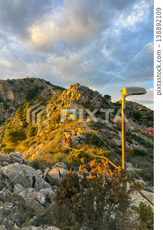 Warm sunset light illuminates Fuengirola city and coastline, viewed from South Viewpoint on Mount Calamorro. Warm sunset light illuminates Fuengirola city and coastline, viewed from South Viewpoint on Mount Calamorro. 138892109
