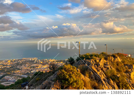 Warm sunset light illuminates Fuengirola city and coastline, viewed from South Viewpoint on Mount Calamorro. Warm sunset light illuminates Fuengirola city and coastline, viewed from South Viewpoint on Mount Calamorro. 138892111