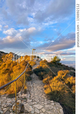 Warm sunset light illuminates Fuengirola city and coastline, viewed from South Viewpoint on Mount Calamorro. Warm sunset light illuminates Fuengirola city and coastline, viewed from South Viewpoint on Mount Calamorro. 138892112