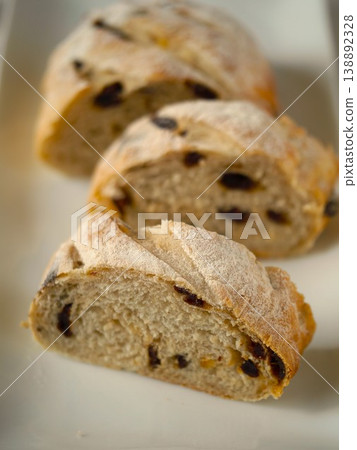 Raisin and orange peel bread, simple background, close-up. 138892328