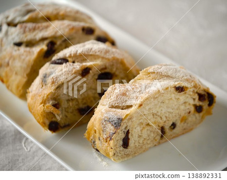 Raisin and orange peel bread; simple background; landscape orientation. Raisin and orange peel bread; simple background; landscape orientation. 138892331