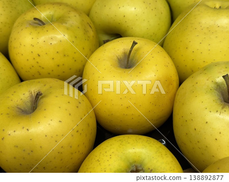 Yellow apples form a vibrant textured background highlighting their freshness and natural appeal 138892877