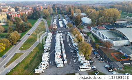 Aerial view highlighting numerous RVs and campers parked at the dedicated facility in Piazzale Azzurri d'Italia, Cremona Aerial view highlighting numerous RVs and campers parked at the dedicated facility in Piazzale Azzurri d'Italia, Cremona 138893938