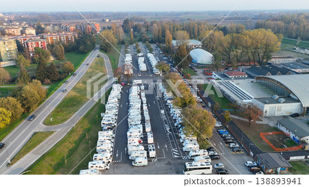 Piazzale Azzuri d'Italia in Cremona operating as a tourist camper parking facility, aerial view of RVs and motorhomes Piazzale Azzuri d'Italia in Cremona operating as a tourist camper parking facility, aerial view of RVs and motorhomes 138893941