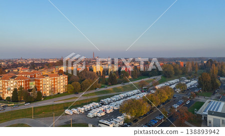 Piazzale Azzuri d'Italia in Cremona, Italy, managing an urban camper van parking area for tourists, aerial view Piazzale Azzuri d'Italia in Cremona, Italy, managing an urban camper van parking area for tourists, aerial view 138893942