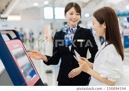 Female airport ground staff providing self-check-in instructions. (Photo courtesy of Kansai International Airport (KIX)) 138894194