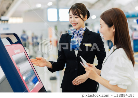 Female airport ground staff providing self-check-in instructions. (Photo courtesy of Kansai International Airport (KIX)) 138894195