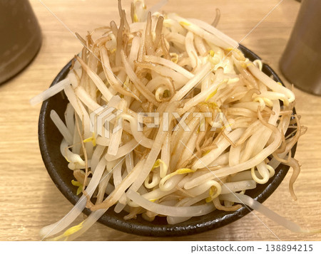 Vegetable topping for tsukemen (dipping noodles): bean sprouts - piled high in a small black bowl (front view) Vegetable topping for tsukemen (dipping noodles): bean sprouts - piled high in a small black bowl (front view) 138894215