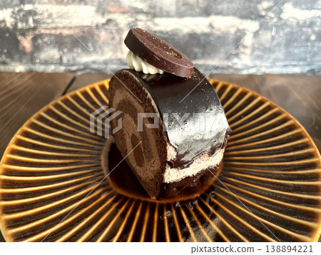 Chocolate roll cake - Side covered in chocolate glaze Chocolate roll cake - Side covered in chocolate glaze 138894221