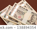 A stack of 10,000 yen bills 138894354