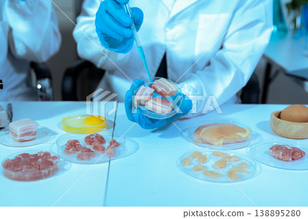 Team Food Safety Scientists Testing Meat Samples in Laboratory for Contamination and Chemical Residue Analysis. 138895280