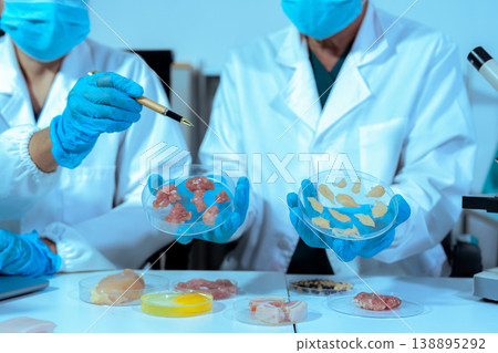 Team Food Safety Scientists Testing Meat Samples in Laboratory for Contamination and Chemical Residue Analysis. 138895292