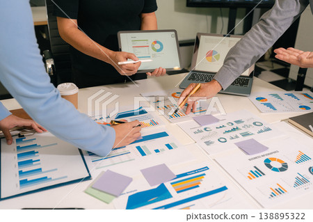 business team working on a project in the office or reviewing and discussing a business project. 138895322