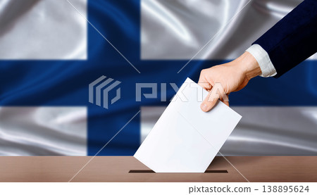 Finland Parliamentary vote 2026. Hand placing a ballot in ballot box with the Finnish flag in the background 138895624