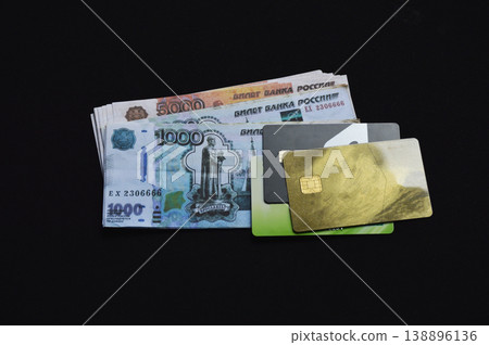 Russian rubles and plastic bank cards on a black background 138896136