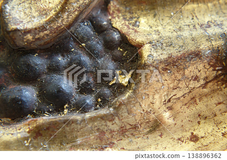 Close View of Textured Surface on a Golden Statue From an Ancient Culture Found in an Archaeological Site 138896362