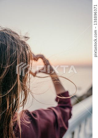 Heart sunset horizon Woman makes a heart symbol with her hands overlooking the sea during a beautiful golden hour Heart sunset horizon Woman makes a heart symbol with her hands overlooking the sea during a beautiful golden hour 138896371